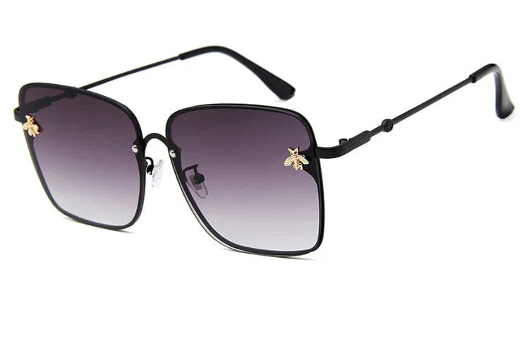 Women's oversized rimless square sunglasses by Showlu Fashion, UV400 gradient lenses, stylish bee-shaped frame for women.