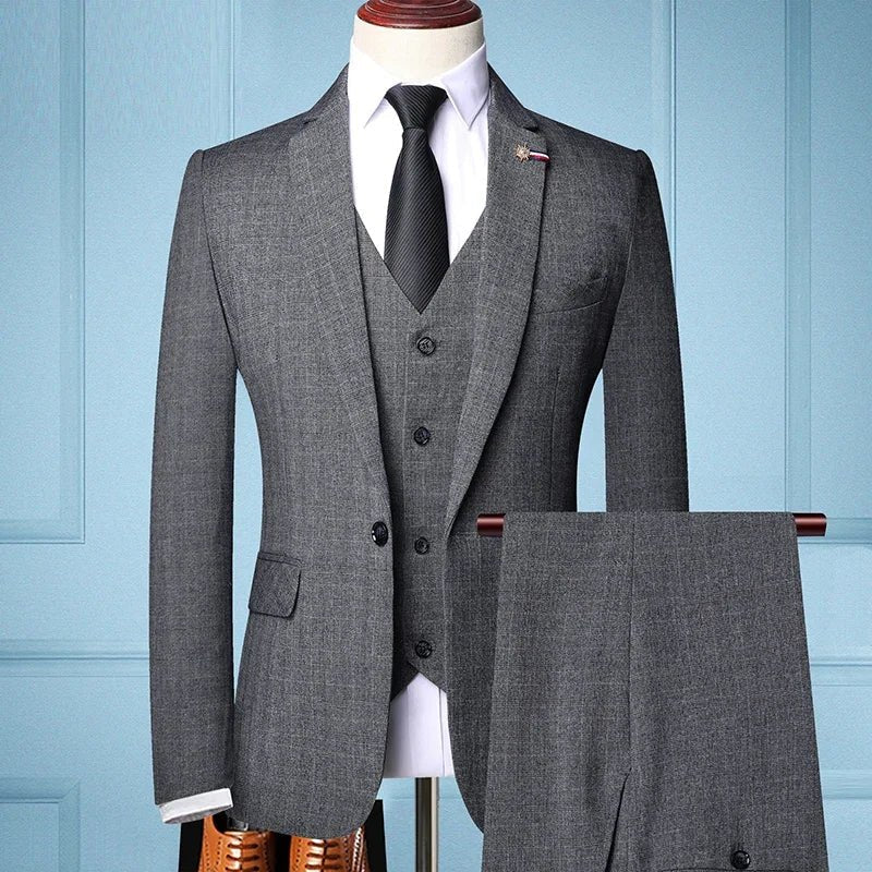 Elegant men's slim fit 3-piece suit with blazer, vest, and pants in a stylish business and wedding fashion look.