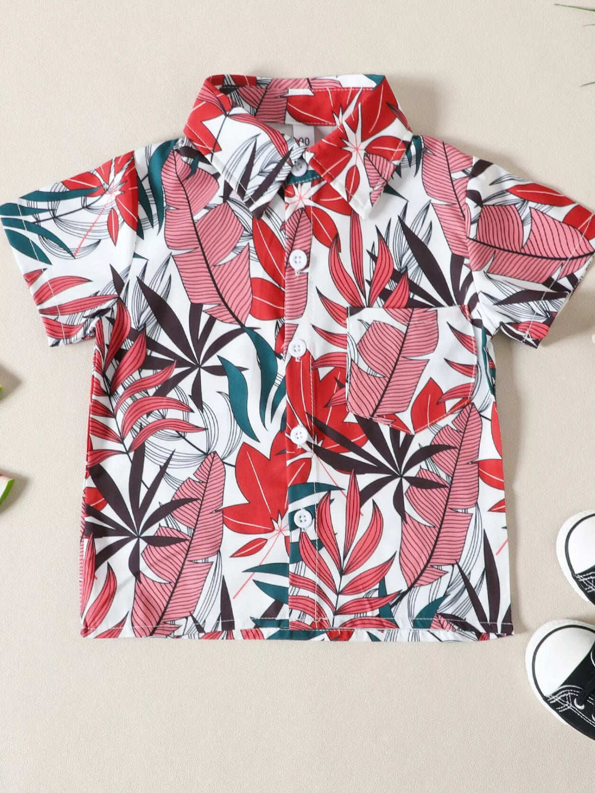 Children's tropical leaf print shirt and shorts set by Trendsi, featuring a vibrant leafy pattern on lightweight fabric.