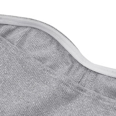 A close-up view of the grey ribbed knit fabric and elasticized neckline of a strapless top.