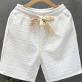 SHOWLU Men's textured drawstring shorts with breathable fabric, relaxed fit, adjustable waist, ideal for summer outdoor and beach wear.
