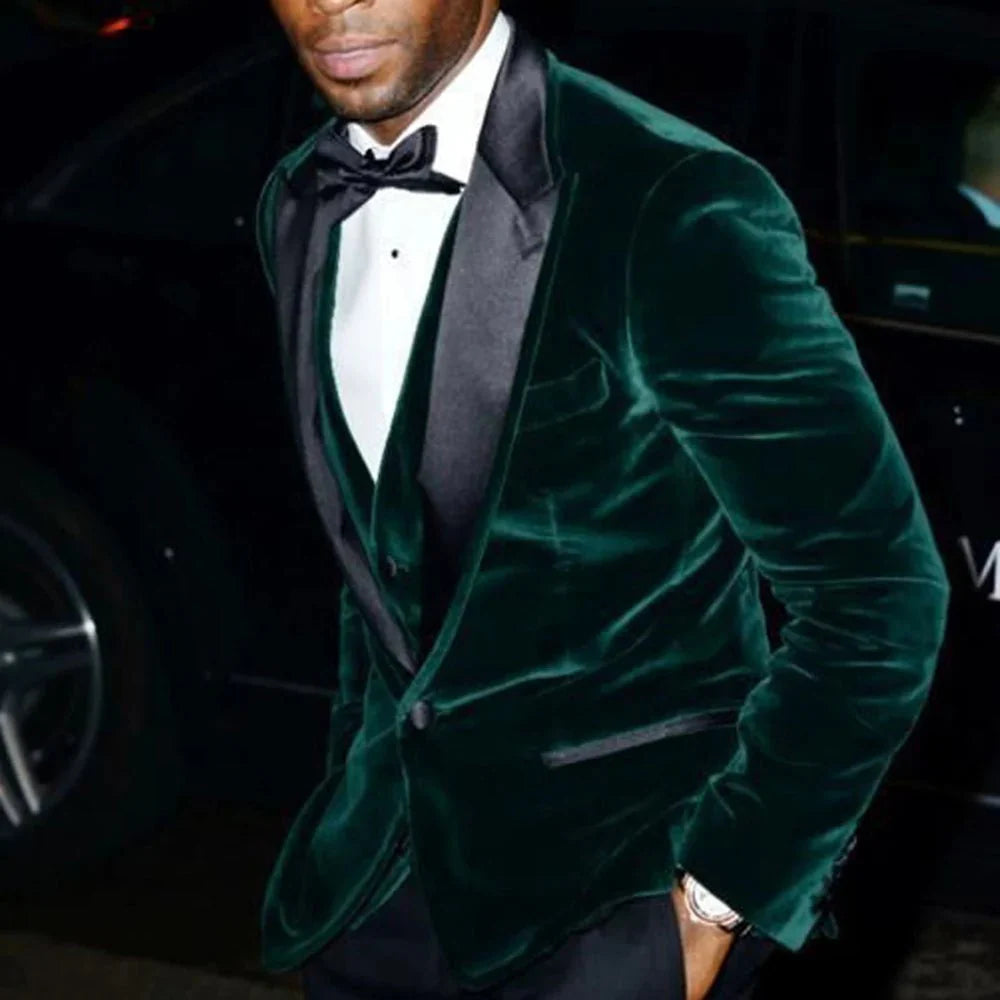Dark green velvet men's 3-piece slim fit wedding tuxedo with black peaked lapel, shown on a model for formal occasion wear