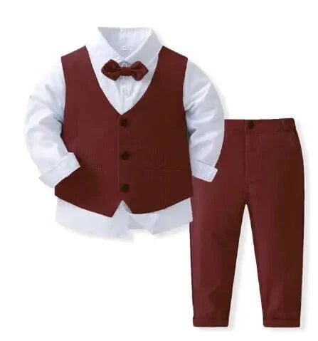 Boy in navy blue tuxedo suit with vest, bowtie, white shirt, and matching pants for wedding or formal occasion.
