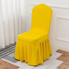 A bright yellow, stretchable chair cover with a pleated skirt design.