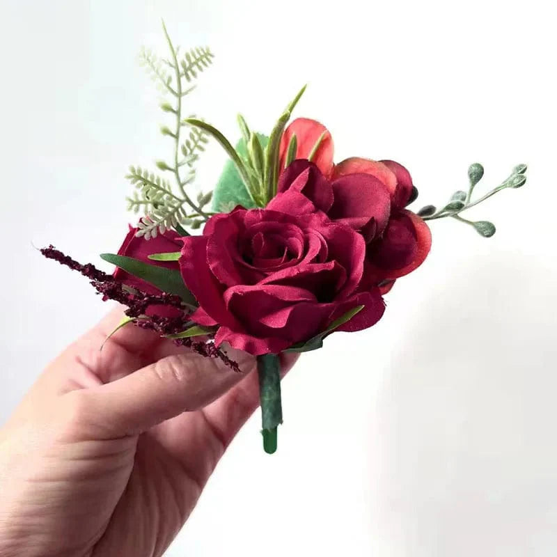 Artificial white silk rose boutonniere and red rose wrist corsage for wedding, with boutonhole and bridal accessories by Showlu Fashion.
