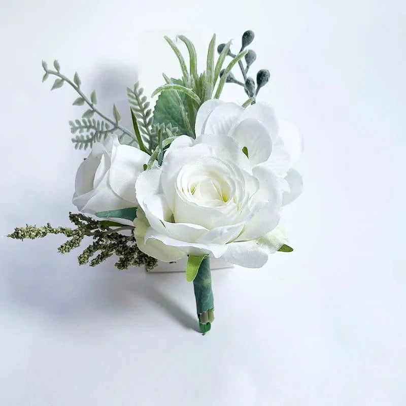 White artificial silk rose boutonniere and wrist corsage with red rose accents, perfect for wedding bridesmaids and guests.