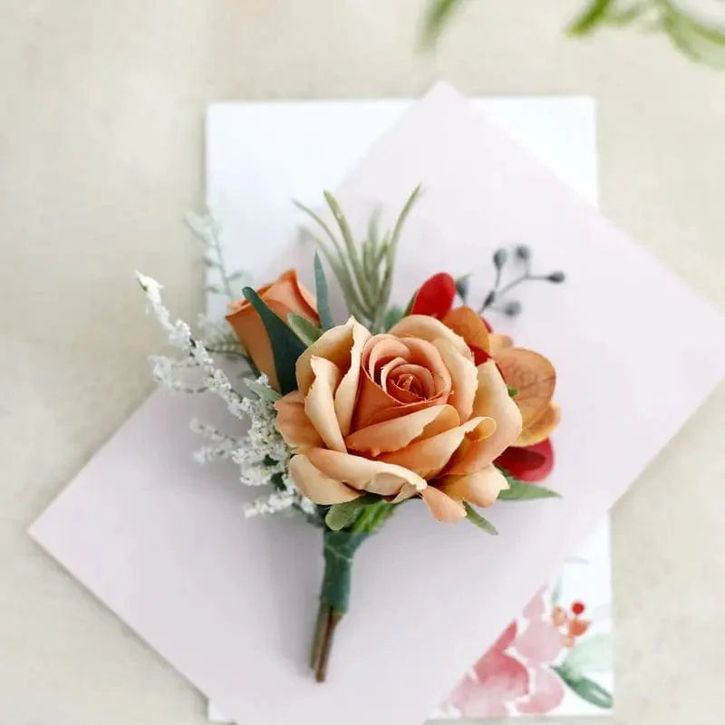 White artificial silk rose boutonniere and wrist corsage with red rose accents, suitable for weddings and formal occasions.