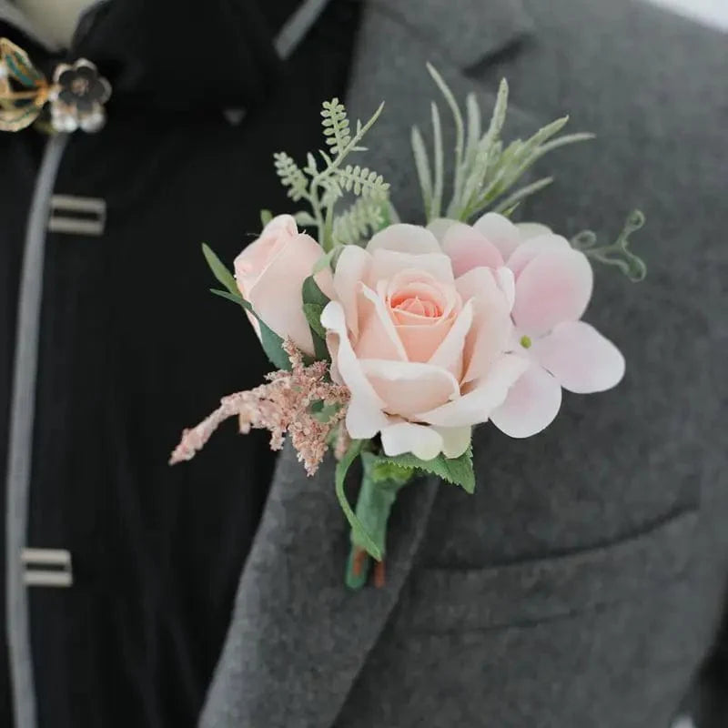 Artificial white silk rose boutonniere and red rose wrist corsage for wedding, suitable for bridesmaids, grooms, and guests.