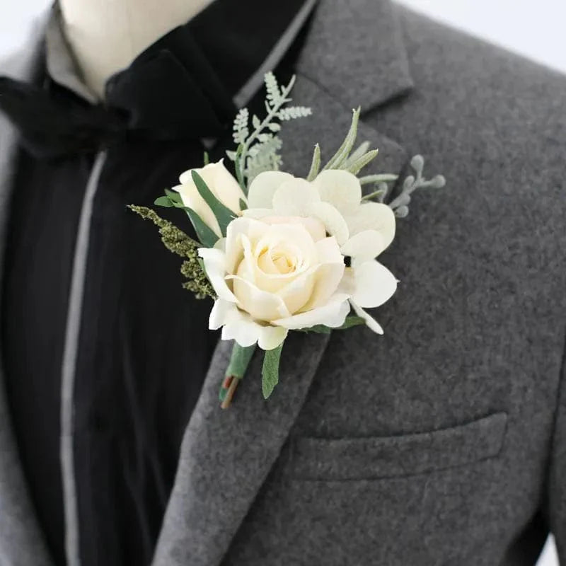 Artificial silk white rose boutonniere and wrist corsage for wedding, featuring red rose accents, suitable for bridesmaids and groomsmen.