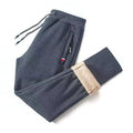 Men's winter fleece joggers with lambswool lining, drawstring waist, straight fit, and casual harem style in solid color.