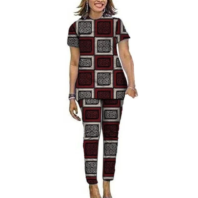 Women wearing Showlu Fashion Women's Ankara African print top and pants set, featuring vibrant Nigerian-inspired patterns.