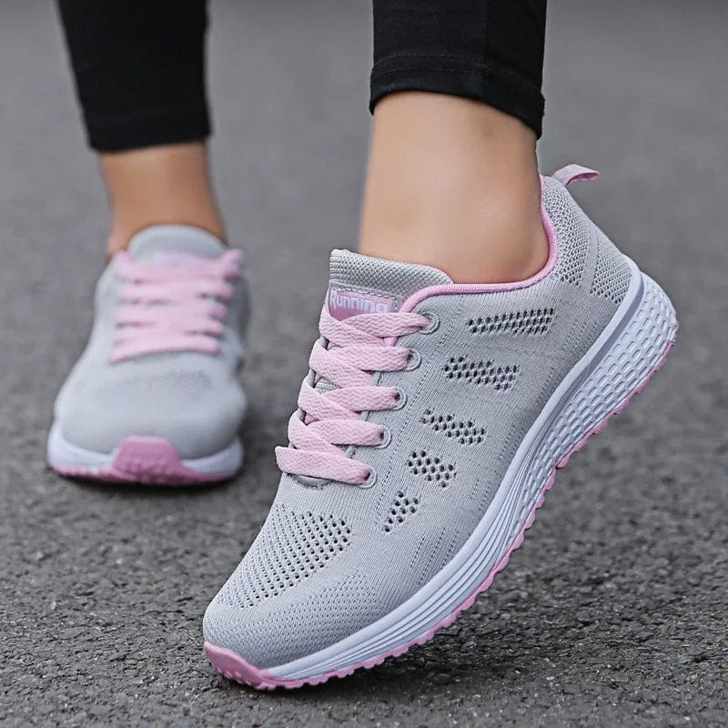 Women’s breathable mesh walking shoes by LIZUXIE, flat lace-up sneakers in white, showcasing casual and gym-ready footwear.