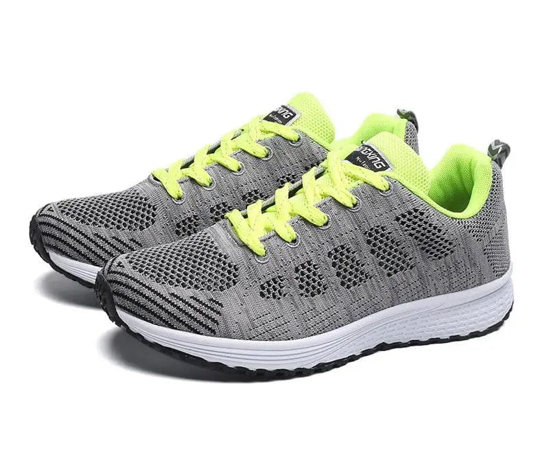 Women’s breathable mesh walking shoes by SHOWLU FASHION STORE, flat lace-up sneakers in white with casual, sporty design.