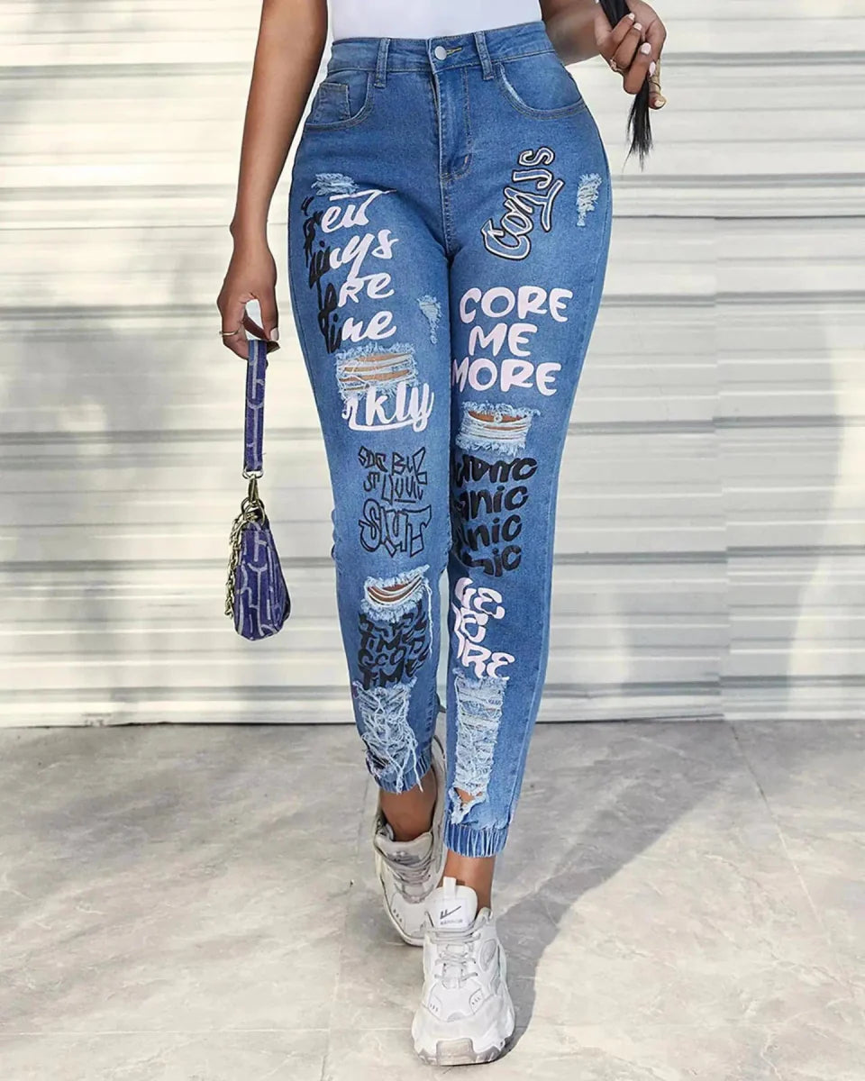Women's slim fit denim pencil jeans with printed ankle-length design, holes, pockets, zipper fly, and slight stretch, by Showlu Fashion.