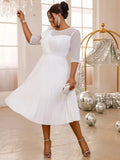 Elegant white pleated tulle dress for women, featuring ruffle details and high waist, perfect for wedding guests and evening events.