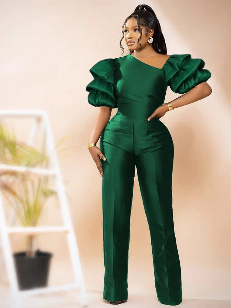 A woman wearing a shiny black AOMEI women's jumpsuit with puff sleeves, skew collar, high waist, and slim fit for summer or office wear.