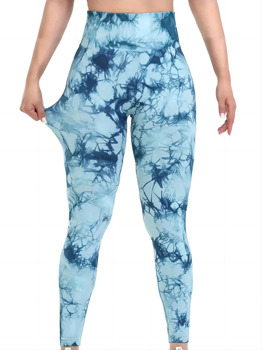 Showlu Women's tie-dye seamless high-waist yoga pants in peach with stretch fabric and fitted design for fitness and yoga activities.
