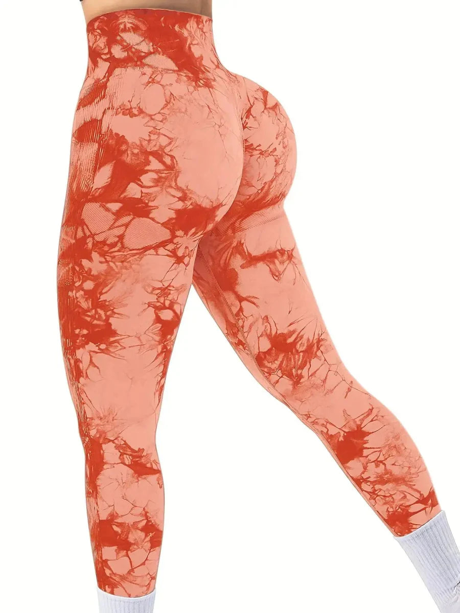 Showlu women's tie-dye high-waist seamless yoga pants in peach, featuring stretch nylon fabric and a fitted athletic design.