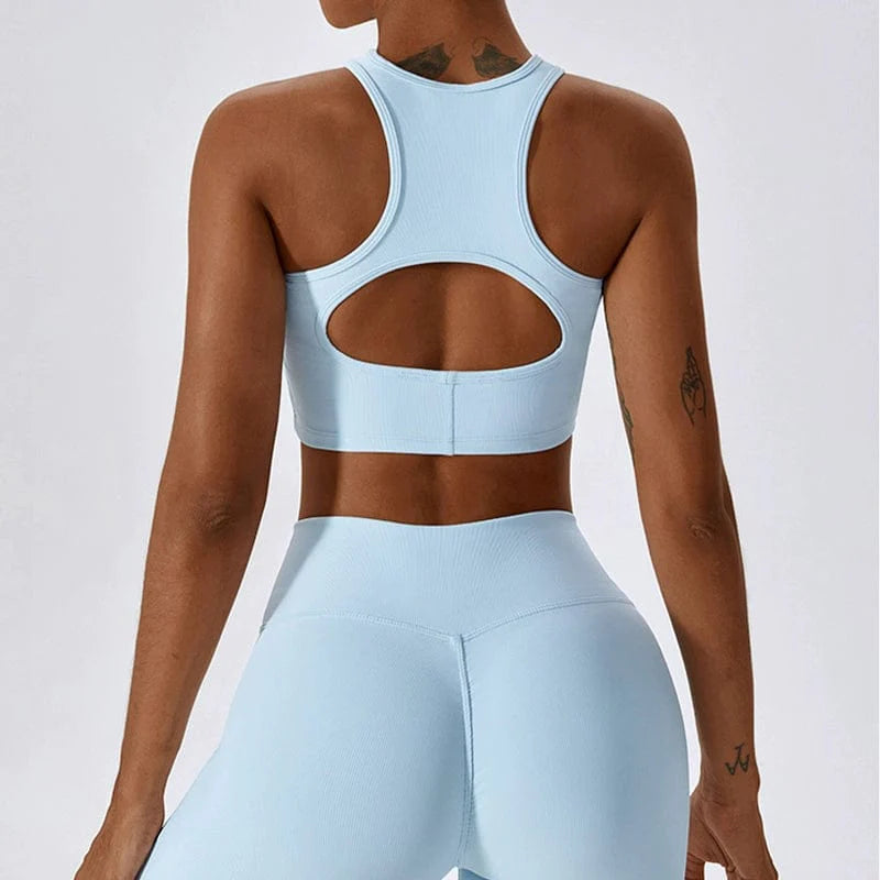 Showlu Fashion hollow-out nylon yoga sports vest with chest pad, form-fitting and designed for active wear and flexibility.