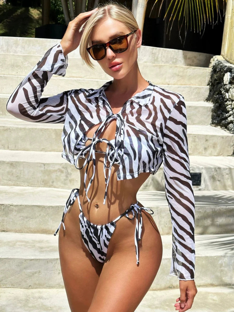 Zebra print hollow-out bikini set with adjustable tie closures by Showlu Fashion, featuring bold black and white pattern and cut-out design.